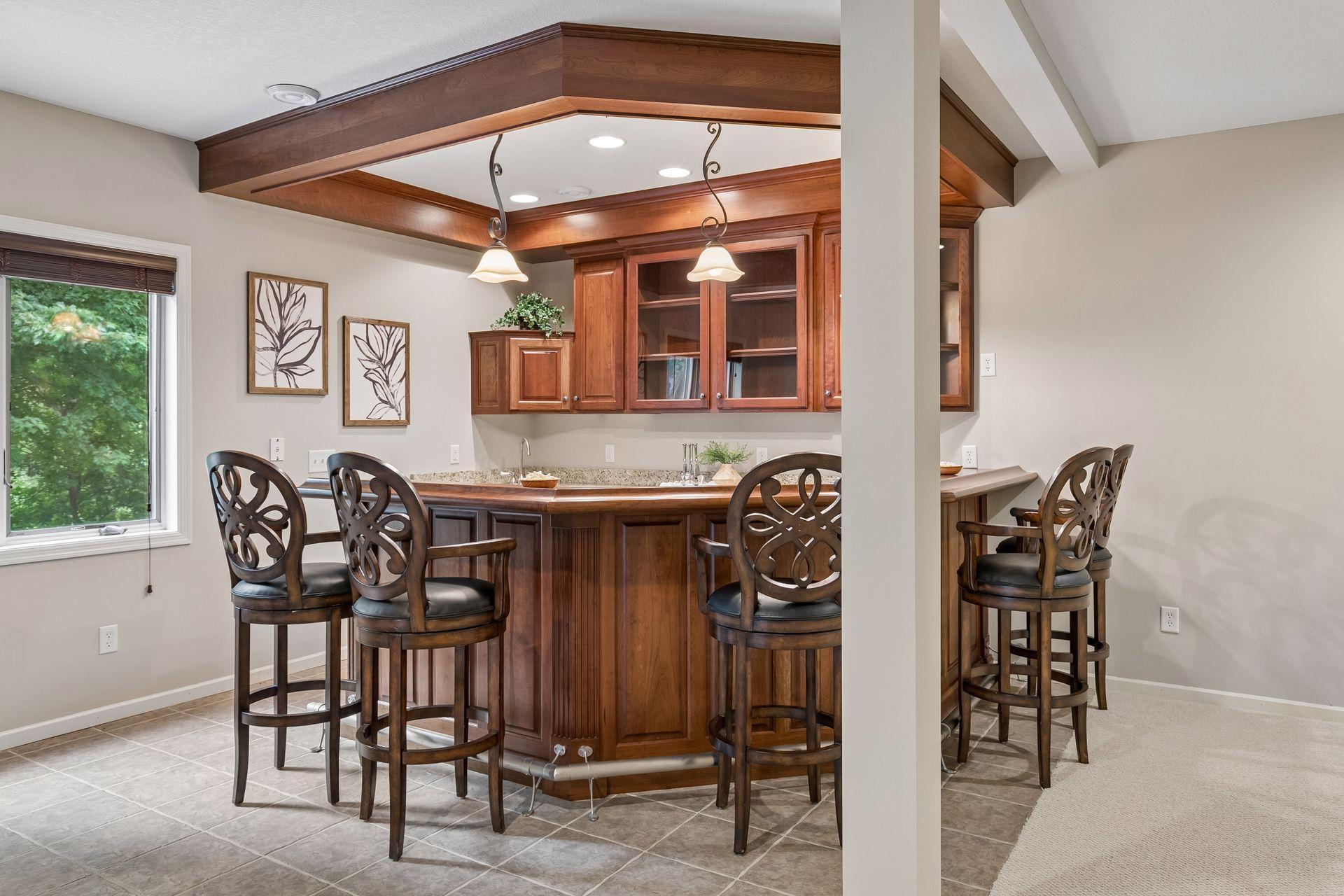 Lower level wrap around bar with mini fridge, dishwasher and sink