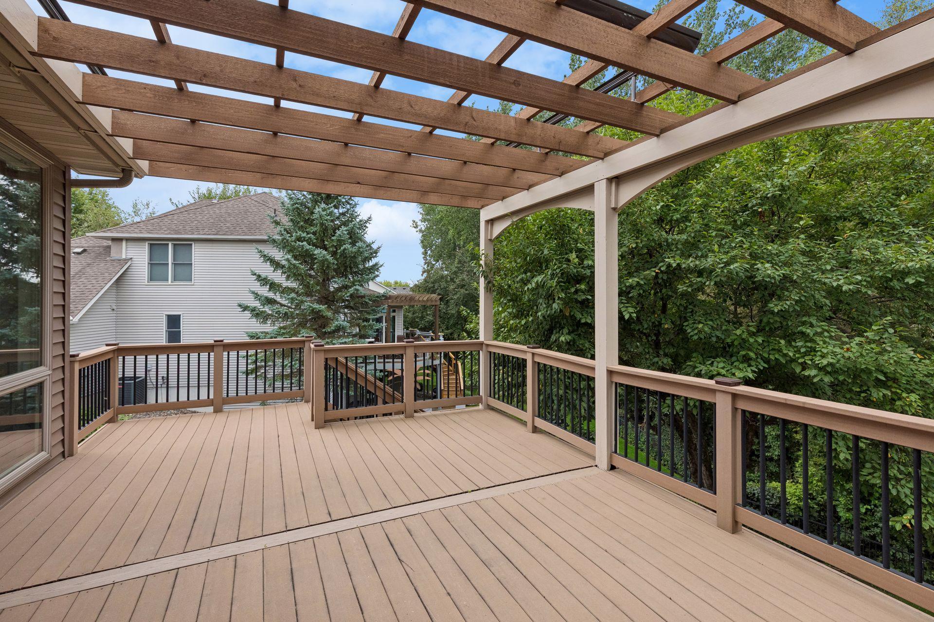 Deck features stairs leading to lower level patio