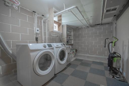 Bright laundry area boasts a front-loading laundry pair