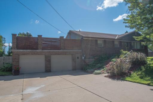 Front view showing the wide concrete driveway with plentiful parking