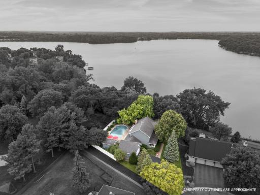 Prime Maple Grove lake front location on Rice Lake! This home’s incredible backyard oasis with pool and bar area, just steps from the lake. Enjoy access to the 3.8-mile walking trail that loops around the entire lake.