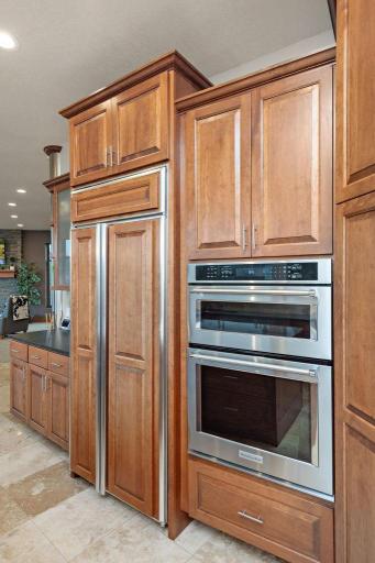 Professional grade ovens, built-in refrigerator, custom cabinetry, offering unparalleled performance and sophistication for the discerning weekend chef.