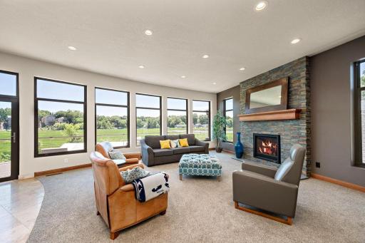 Floor to ceiling stacked stone gas fireplace and new carpet throughout offers a cozy feel in in a breathtaking entertainment space. 2022 - Professionally painted main floor and upper level including ceiling.