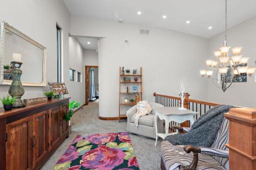 Perched atop the estate, your private third-floor primary suite is a serene retreat, featuring a luxurious en suite, this intimate lounge, and breathtaking views of Lake Minnetonka from your 1,656 SQFT rooftop deck.