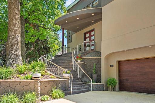 A grand portico welcomes you, featuring stately 8ft double door entry - solid wood and protective fiberglass with top to bottom frosted glass accent. A statement piece!