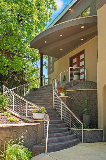A show-stopping sweeping staircase ascends gracefully to the main entry, embodying timeless elegance and luxury appeal.