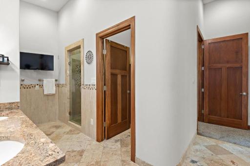 Love this space! Finally practical spaces in an en-suite bath! The primary en-suite bath boasts dual vanities, a jacuzzi tub, walk-in shower, private water closet, and radiant heated floors - with direct access to your walk-in closet.