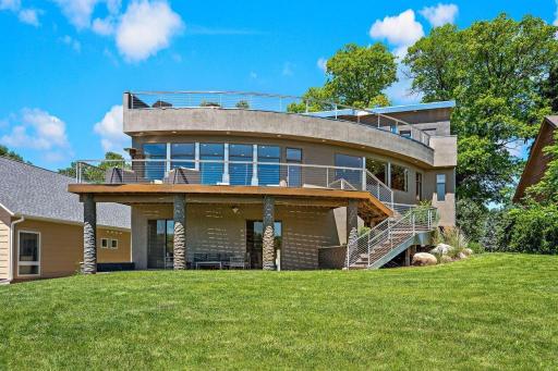 An equally impressive staircase connects the main-floor deck and lower level patio also watched over by motion sensor lighting. 30x10 Patio is hardwired with weather protected outlet for hot tub. Both sliding doors access the LL Family Room.