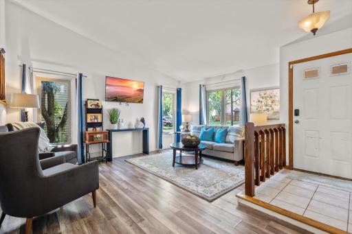Main level living room is flooded with natural light.