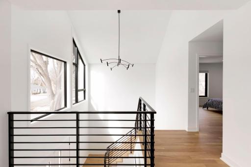 A custom iron railing offers a sleek and airy design