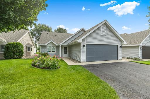 Welcome to a thoughtfully designed patio home featuring maintenance-free metal siding, seamless rain gutters, architectural shingles new in 2023, and an asphalt driveway leading to a fully finished garage.