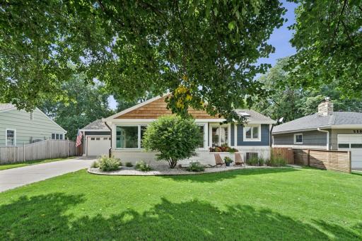 Inviting front exterior with modern curb appeal, updated siding, and a landscaped yard.