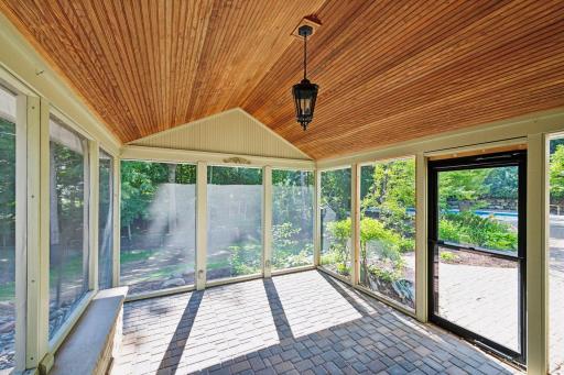 Screen porch off kitchen and walks out to huge paver patio