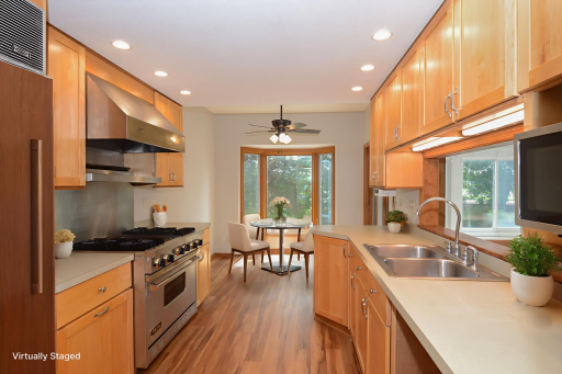 Chef’s dream kitchen featuring high-end appliances including Viking gas range, Sub-Zero refrigerator and brand new Bosch dishwasher, space for informal dining and a pass-through to the living room to enhance your views from all angles.