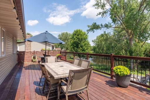 Massive 46+’ cedar deck built in 2020 extends entire length of the home & overlooks a beautifully sculpted backyard w/wood privacy fence, raised garden beds, fire pit & peaceful pond, which is part of Evergreen Ponds & connects to Kerry Lake!