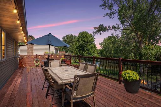 Massive 46+’ cedar deck built in 2020 extends entire length of the home & overlooks a beautifully sculpted backyard w/wood privacy fence, raised garden beds, fire pit & peaceful pond, part of Evergreen Ponds & connects to Kerry Lake! Virtual twilight