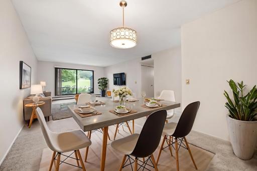 Large and open dining room to living room with updated fixtures. Virtually staged