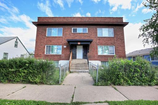 Great curb appeal with warm brick colored tones and newer flat roof!