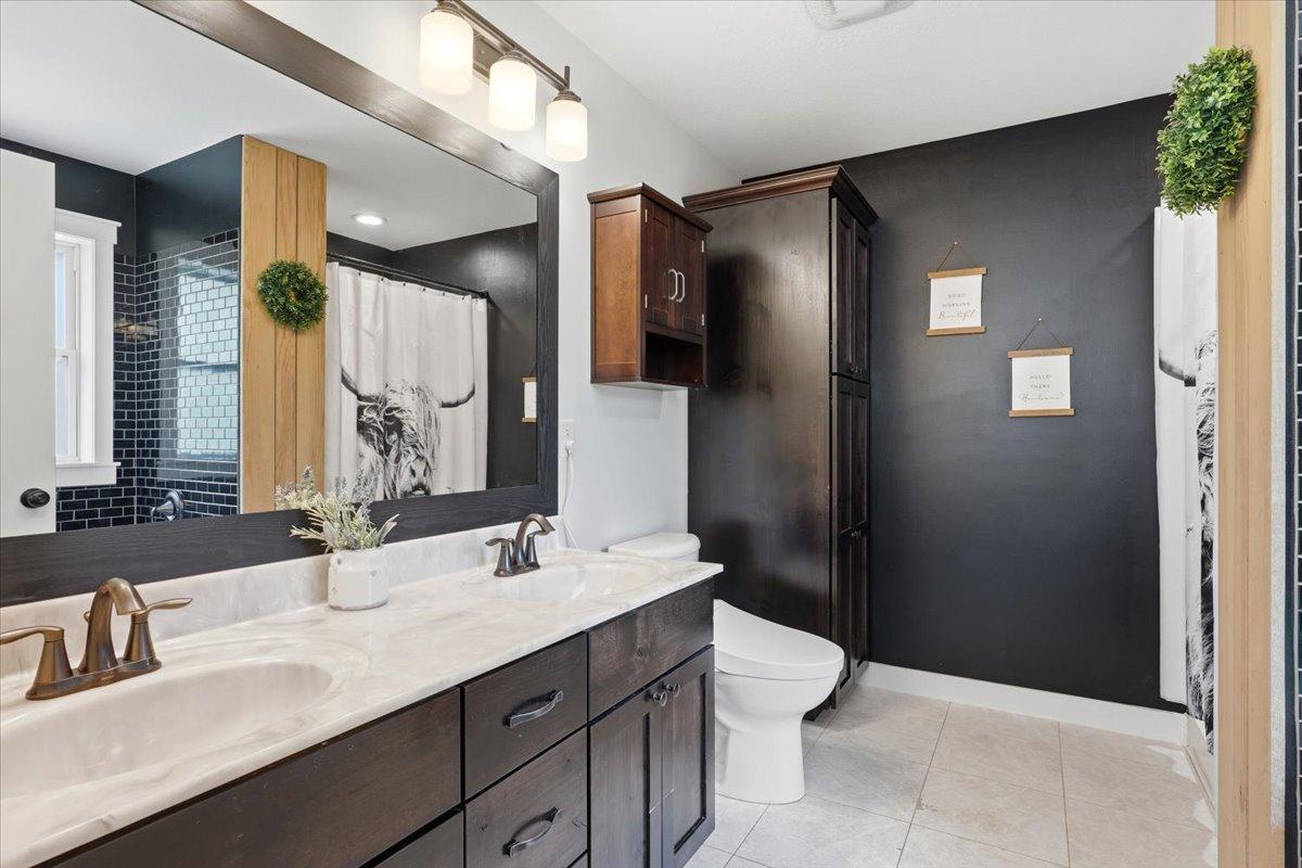 Primary ensuite with storage, shower and soaker tub, tiled and styled classically but modern just like the rest of the home