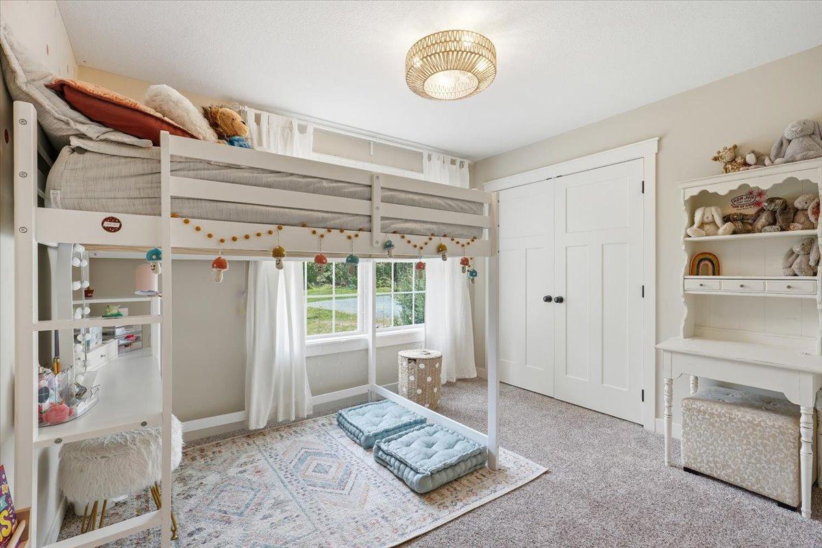 Bedroom 2, located on the main floor offers a large closet and beautiful windows