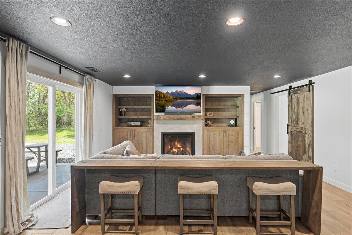 The family room has gorgeous built-ins, a second gas fireplace and the perfect space for relaxing with a sliding door to the patio