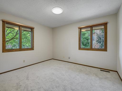 The second bedroom on the main level has great windows, new carpet and is a perfect space for kids or guests.