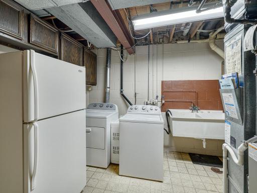 The laundry room has a sink and an extra fridge/freezer for added convenience.