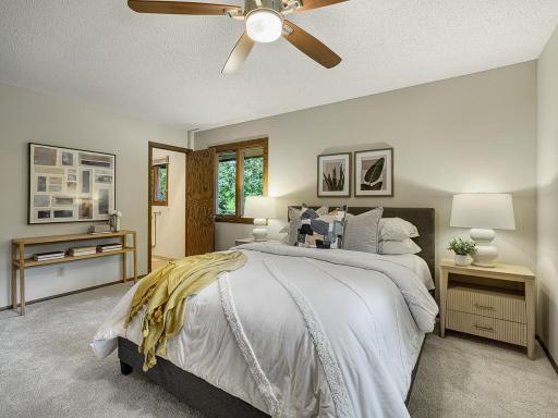 The primary bedroom allows for walk-through access to the main level full bath.