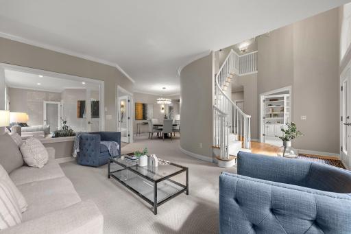 Another angle of the formal living room, showcasing its connection to the adjoining sunroom.