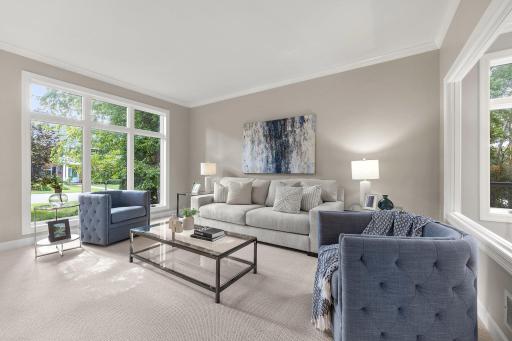 The formal living room, located near the front entrance of the home, features brand-new plush carpeting and picturesque views of the front yard.