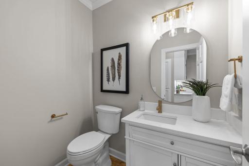 Completing the main level is a convenient powder room, thoughtfully positioned for guests and everyday use.