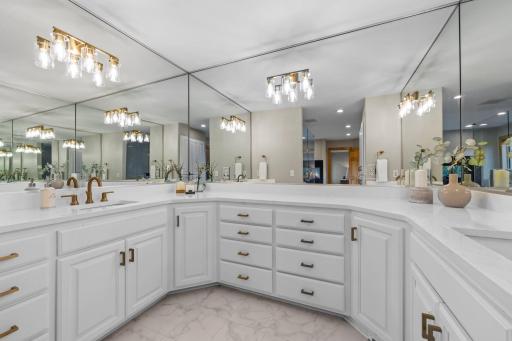 An expansive dual-sink vanity provides ample counter space, making your morning and evening routines both comfortable and convenient.