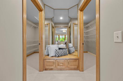 Spacious 11x6 his-and-hers walk-in closets featuring a combination of wire and wood built-ins for versatile storage.