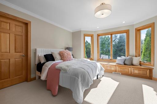 Located on the upper level, Bedroom Two is thoughtfully designed with comfort and style in mind. It features a spacious walk-in closet, a charming bay window with built-in bench seating, cozy carpeting, and lovely views of the front yard.