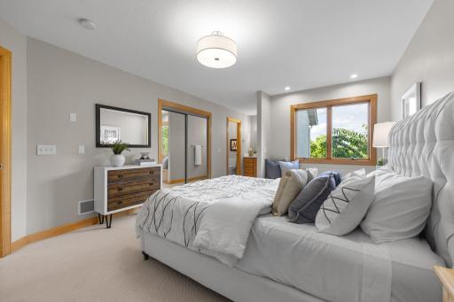 This room also enjoys the convenience of a private full bathroom, complete with a separate vanity area for added functionality and comfort.