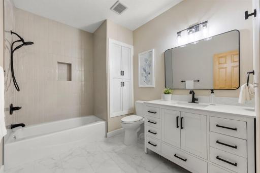 An additional full bathroom down the hall offers tile floors, a tub and shower combo, and a single vanity with cabinetryâperfect for accommodating guests or a larger household.
