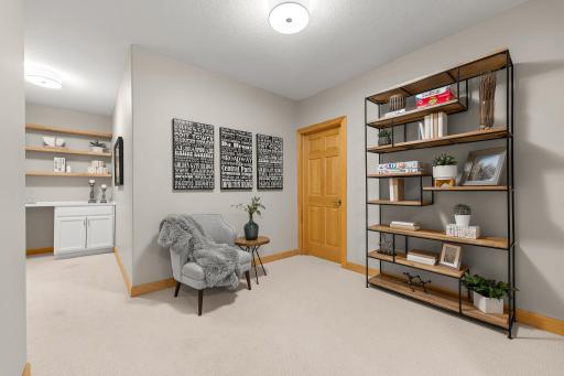 A comfortable sitting area located near the lower-level unfinished storage space.