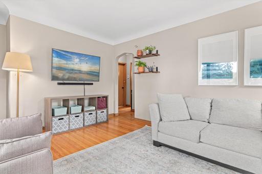 The living room features beautiful hardwood floors