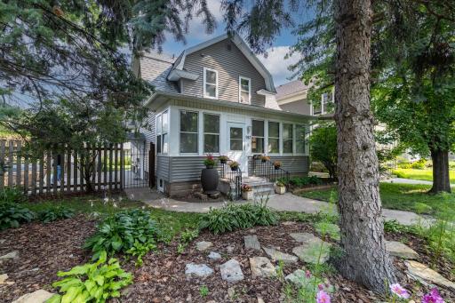 This Dutch Colonial home, with a gambrel roof; welcomes you with vibrant perennials adding color and charm. Newly poured concrete steps provide a fresh, clean entrance, while a rain barrel collects water sustainably.