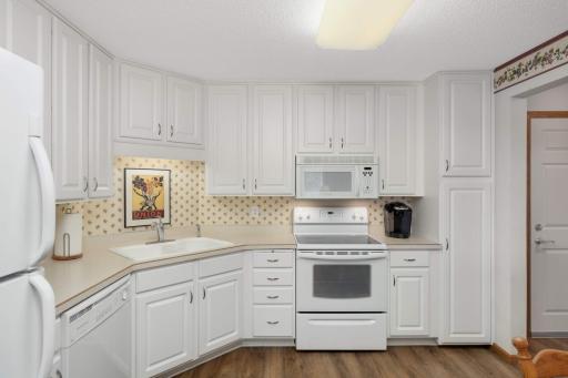 Well-designed and functional, the kitchen features generous cabinetry and counter space, perfect for daily cooking