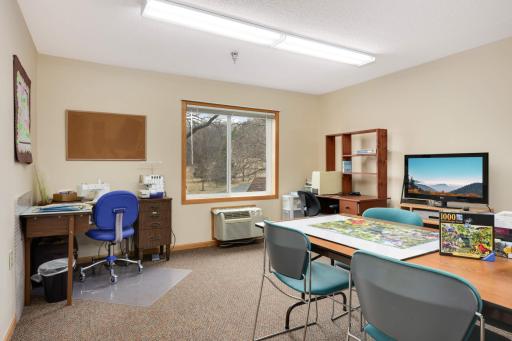 Bright and inspiring, the craft room offers ample space and supplies for creative projects and hobbies