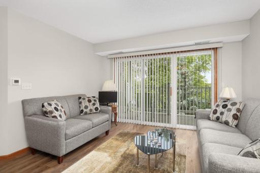 The living room flows seamlessly into the dining area, offering a comfortable setting for gatherings or quiet evenings at home