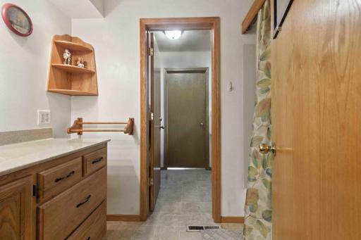Full bathroom with stool in adjoining room
