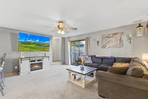 Spacious main level living room with patio doors that lead out to the fenced yard.