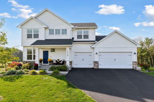 Absolutely gorgeous! Modern Craftsman style with lush landscaping, an inviting front porch, and a backdrop of beautiful Wisconsin woodlands — this home is picture-perfect from every angle.