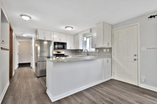 Remodeled Kitchen with new cabinets - solid surface countertops