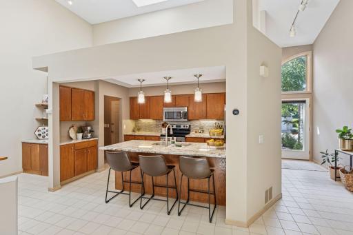 This stunning townhome features an open-concept layout with soaring vaulted ceilings, bright off-white walls, and a skylight!