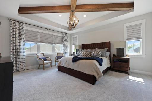 Spacious primary bedroom with abundance of natural light