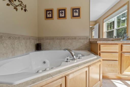 The walk-through bathroom includes a separate shower and jetted tub.