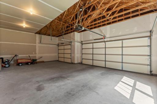The three car garage offers plenty of space for parking, working on projects, or extra storage.